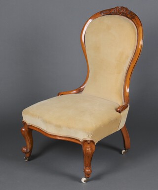 A Victorian bleached carved mahogany show frame nursing chair upholstered in mushroom coloured material, raised on cabriole supports 93cm h x 57cm w x 55cm d (seat 26cm x 34cm) 