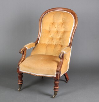 A William IV mahogany show frame button back open armchair, the seat and back upholstered in mustard coloured material, raised on turned supports with brass casters 116cm h x 58cm w x 59cm d (seat 26cm x 30cm) 