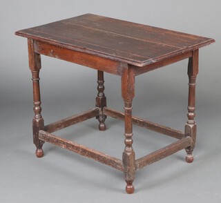 An rectangular oak table (made up of 18th and 19th Century timber), raised on turned supports with box framed stretcher and turned feet 71cm h x 92cm w x 56cm d 