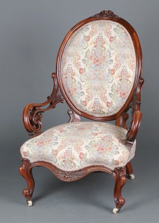 A Victorian mahogany show frame open arm chair, the cresting rail carved fruit, having pierced arms, the seat of serpentine outline, raised on French cabriole supports  104cm h x 64cm w x 55cm d (seat 30cm x 42cm) 