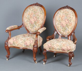 A Victorian carved walnut show frame open arm chair with carved cresting rail and serpentine fronted seat, raised on carved supports with ceramic casters 61cm h x 47cm, together with a matching nursing chair 101cm x 54cm w x 51cm d 