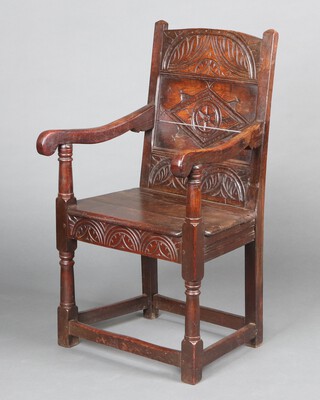 A Victorian 17th Century style carved Wainscot chair with panelled back and solid seat, raised on turned and block supports 99cm h x 56cm w x 49cm d (seat 32cm x 30cm)  