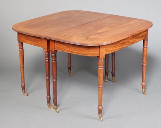 A Georgian mahogany D end dining table with 1 extra leaf, raised on 8 turned supports with brass caps, casters 73cm h x 106cm w x 113cm l x 168cm with leaf 