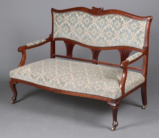 An Edwardian mahogany double chair settee, the seat and back upholstered in green and floral patterned material, raised on cabriole supports supports 120cm h x 121cm w x 59cm d (seat 96cm x 40cm)