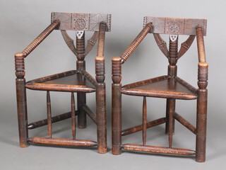 A pair of Victorian carved oak turner's chairs with triangular seats and folding arms 86cm h x 62cm w x 52cm d (seats 26cm x 27cm)