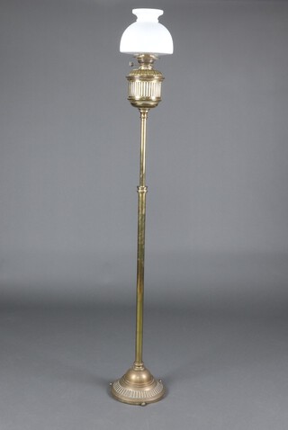 A Hinks & Sons Patent Victorian reeded brass adjustable oil lamp with an opaque glass shade on a circular base 163cm h 