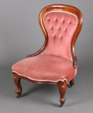 A Victorian mahogany show frame nursing chair upholstered in pink buttoned material, seat of serpentine outline, raised on cabriole supports 94cm h x 65cm w x 54cm d (seat 33cm x 32cm) 