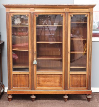 A 19th Century French mahogany and inlaid brass triple bookcase with pink and white veined marble top, fitted adjustable shelves enclosed by glazed panelled doors with fluted columns, raised on bun feet 163cm h x 146cm w x 40cm d 