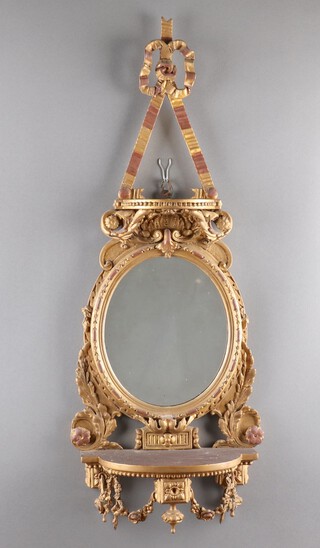 A Victorian oval plate mirror contained in a carved wood and plaster gilt frame incorporating a bracket to the base 91cm h x 37cm w 