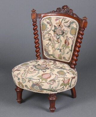 A Victorian carved oak show frame slat back nursing chair with carved cresting rail and spiral turned columns to the sides, upholstered in yellow floral patterned material, raised on turned feet 72cm h x 51cm w x 43cm d (28cm x 26cm) 
