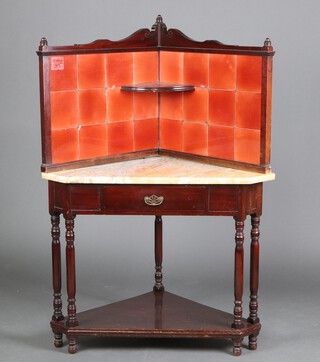 An Edwardian mahogany corner wash stand with red tiled splash back and white veined marble top, the base fitted a drawer, raised on turned supports 140cm h x 97cm w x 69cm d 