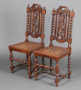 A pair of Victorian Carolean style carved oak high back hall chairs with spiral turned columns to the sides and solid seats, raised on spiral turned supports with H framed stretcher 107cm h x 45cm w x 40cm d  
