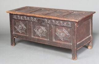 A 17th Century oak coffer of panelled construction with hinged lid, the front with faux iron lock and arcaded carving, the panels carved diamonds 62cm h x 140cm w x 58cm d 