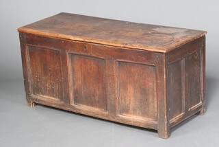 An 18th Century oak coffer of panelled construction with hinged lid and iron lock, long iron hinges, 57cm h x 121cm w x 50cm d 