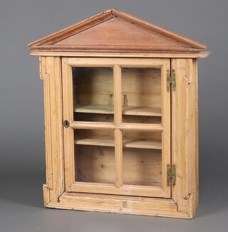 A Georgian pine hanging cabinet fitted shelves enclosed by astragal glazed panelled door with later oak and pine pediment 94cm h x 81cm w x 20cm d 