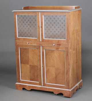 Standard Folding Bed Company Ltd, an Edwardian light oak enclosed wash stand with hinged lid fitted a mirror, above short drawers with recess and sliding white veined marble tray enclosed by a pair of etched panelled glazed doors, fitted a brushing slide above 2 short, 1 long and 2 short drawers enclosed by panelled doors, raised on bracket feet 128cm h x 90cm w x 50cm d 