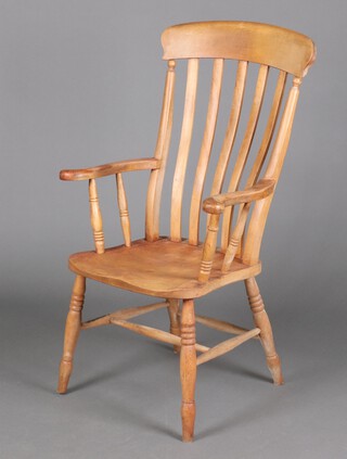 A 19th Century stained pine Gothic comb back Windsor chair with solid seat, raised on turned supports, the seat impressed F M, 115cm h x 63cm w x 41cm d (seat 23cm x 30cm)