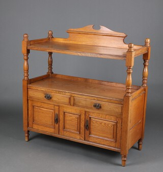 A Victorian light oak 2 tier buffet fitted 2 drawers above cupboards enclosed by panelled doors 109cm h x 102cm w x 43cm d 