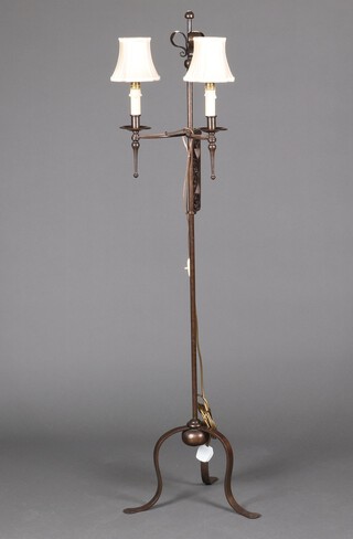 A wrought iron adjustable twin light standard lamp on a tripod base 144cm h x 43cm 