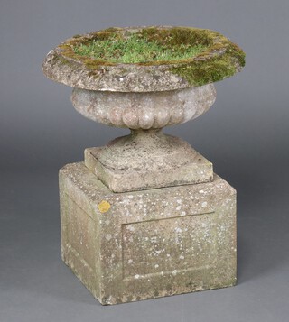 A well weathered circular shallow concrete garden urn with lobed body on a square pedestal base 76cm h x 58cm diam. (in 3 sections) 