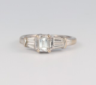 An 18ct white gold Art Deco style ring, the centre diamond 0.4ct, the tapered baguette cut diamonds 0.6ct, size F, 2 grams 