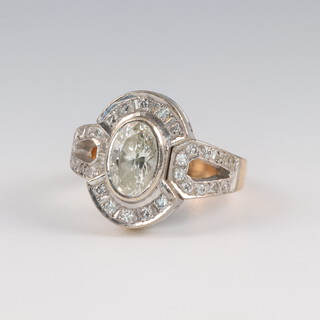 A yellow gold, testing as 14ct, oval diamond cluster ring, the centre stone 2ct, surrounded by brilliant cut diamonds 0.25ct, size I 1/2,  7.4 grams, the centre stone colour G/H, clarity SI1 