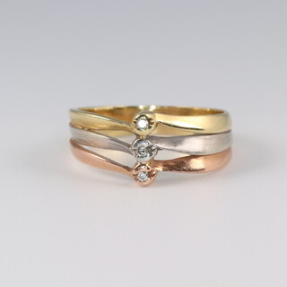 A 3 colour gold, testing as 9ct, 3 stone diamond ring, approx 0.01ct, size P 1/2, 3.5 grams 