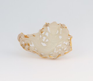 A carved jade brooch in the form of a reclining figure with 22ct yellow gold mount 50mm, 16.2 grams gross