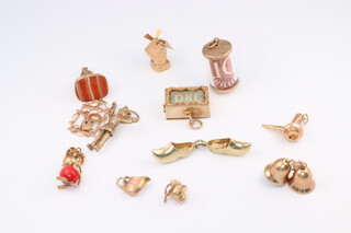 Twelve 9ct yellow gold charms, gross weight 23 grams 