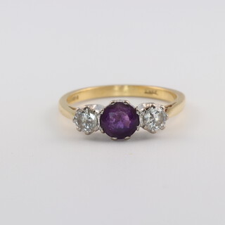 An 18ct yellow gold amethyst and diamond ring, the central brilliant cut amethyst approx. 0.5ct, the 2 brilliant cut diamonds each approx. 0.30ct, size M  4.2 grams, 