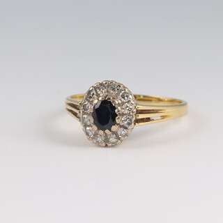 An 18ct yellow gold sapphire and diamond cluster ring, the sapphire 0.25ct approx. 0.12ct, 3.7 grams, size P 1/2