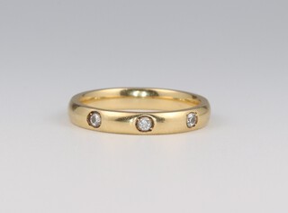 An 18ct yellow gold diamond set wedding band, size N, the diamonds 0.01ct, 3.9 grams 