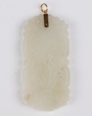 A carved green hardstone pendant with gilt metal mounts 8cm 