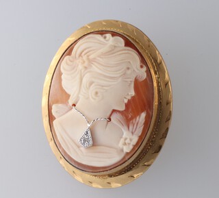A gilt cameo brooch the sitter wearing a diamond pendant 35mm