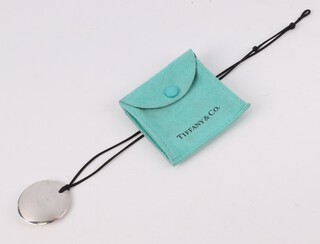 Elsa Peretti for Tiffany, a circular silver pendant 35mm with pouch