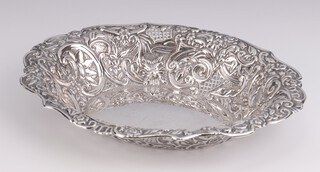 An Edwardian silver oval repousse dish decorated with scrolls and flowers, Sheffield 1903, 27cm, 356 grams 