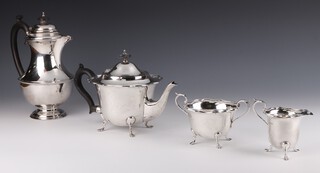 A silver 4 piece tea and coffee set with ebony mounts comprising coffee pot Chester 1932, teapot, sugar bowl and cream jug Sheffield 1915, 1168 grams gross 