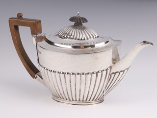 An Edwardian silver demi-fluted teapot with ebony mounts London 1901, gross weight 508 grams 