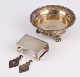 A circular silver bowl on claw feet, London 1919, 2 silver fobs and a match box holder, 116 grams 