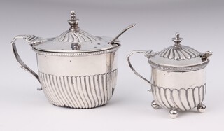 A Victorian silver demi-fluted oval mustard London 1893, a circular silver ditto London 1898 and 2 spoons, 150 grams  