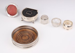 A silver mounted coaster Sheffield 1924, a napkin ring, mustard, a frame and a trinket jar and box with tortoiseshell lid (a/f)