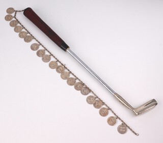 A presentation miniature golf putter inscribed "To Harry Secombe from a grateful record company, Phonogram Conference 1875" to which are attached 20 sterling silver charms with inscriptions dated from 1950 to 1975