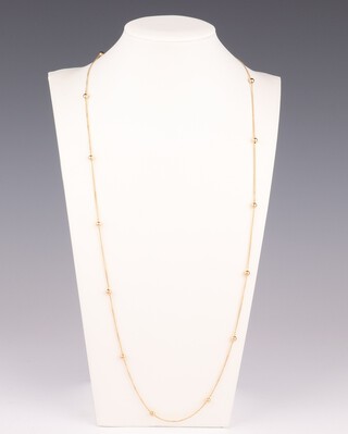 An 18ct yellow gold necklace with 15 ball spacers, 64cm, 4.2 grams 