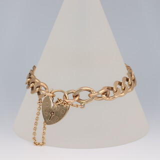 A 9ct yellow gold flat link bracelet with heart padlock 18cm, 23.4 grams 