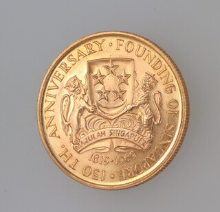 A gold 1969 Singapore 150 dollar coin