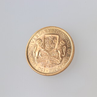A gold 1969 Singapore 150 dollar coin 