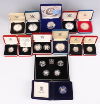 A cased set of 4 United Kingdom one pound silver proof Piedfort coins 1984 - 1987, 4 other one pound silver proof coins, 6 commemorative crowns, a proof silver five pence 2 coin set and a silver proof twenty pence piece, 338 grams 