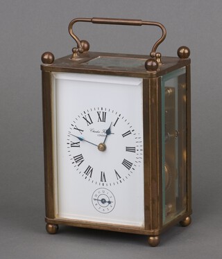 Charles Frodsham London, a 20th Century striking carriage alarm clock, the 7.5cm enamelled dial marked Charles Frodsham London, Roman numerals and alarm hand, contained in a gilt case, the under side marked SER.No.038, 14cm h x 10cm w x 7cm d, complete with key 