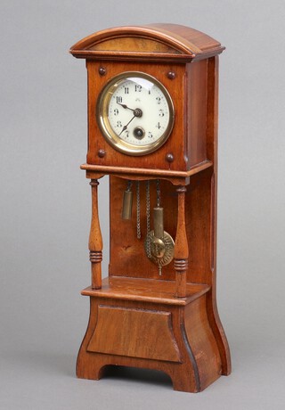Gustav Becker, a miniature longcase clock with 5cm enamelled dial, Roman numerals, contained in a mahogany finished case complete with pendulum and key, 20cm x 10cm x 6cm 