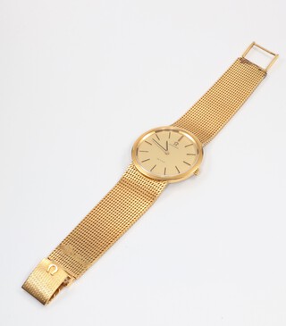A gentleman's 9ct yellow gold Omega Deville quartz wristwatch contained in a 9ct, 33 gram case, on a ditto mesh bracelet, 44 grams included the glass 